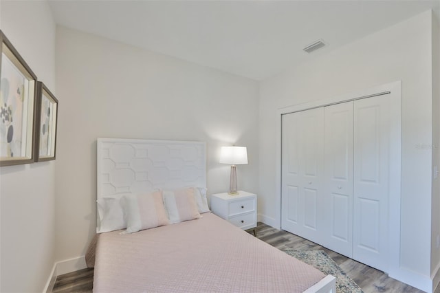 bedroom with hardwood / wood-style flooring and a closet