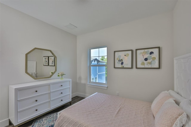 bedroom featuring dark hardwood / wood-style flooring