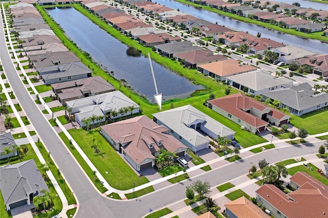 bird's eye view featuring a water view and a residential view