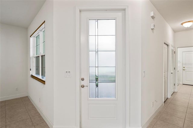 entryway with light tile patterned flooring