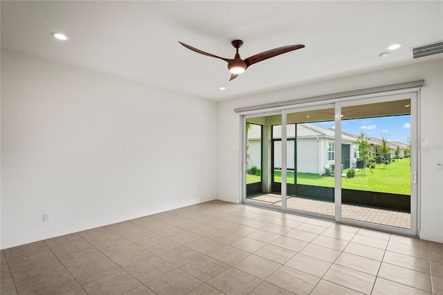 tiled empty room with ceiling fan