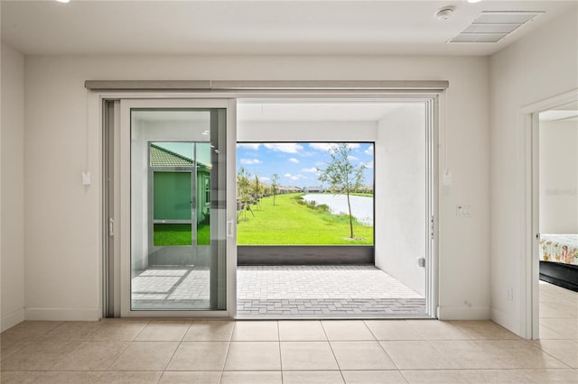 doorway with visible vents, baseboards, and light tile patterned flooring