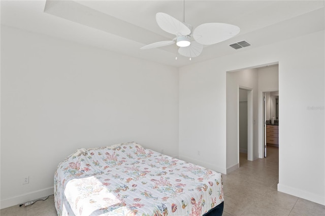 bedroom featuring light tile patterned floors, baseboards, visible vents, and a ceiling fan
