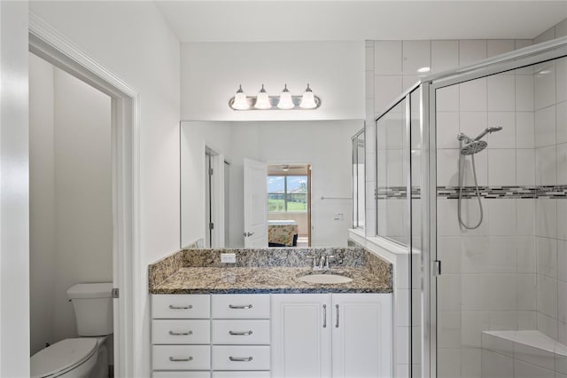 full bath featuring a shower stall, toilet, and vanity