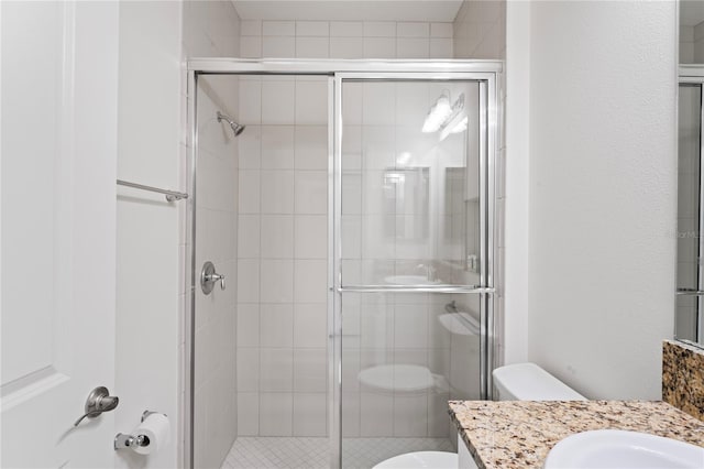 bathroom with a shower with door, toilet, and vanity