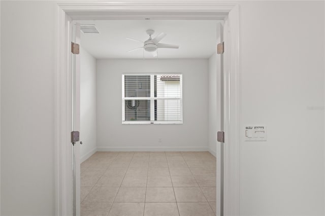 unfurnished room featuring visible vents, ceiling fan, baseboards, and light tile patterned floors