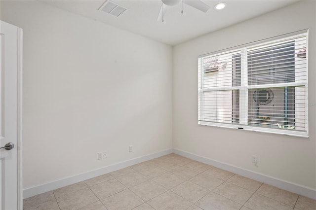 empty room featuring visible vents, ceiling fan, baseboards, and light tile patterned floors