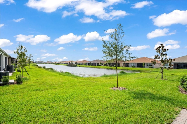 view of yard with a water view, cooling unit, and a residential view
