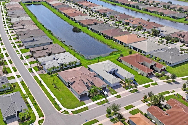 birds eye view of property featuring a water view and a residential view