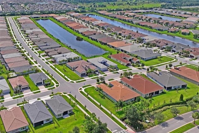 birds eye view of property featuring a residential view and a water view