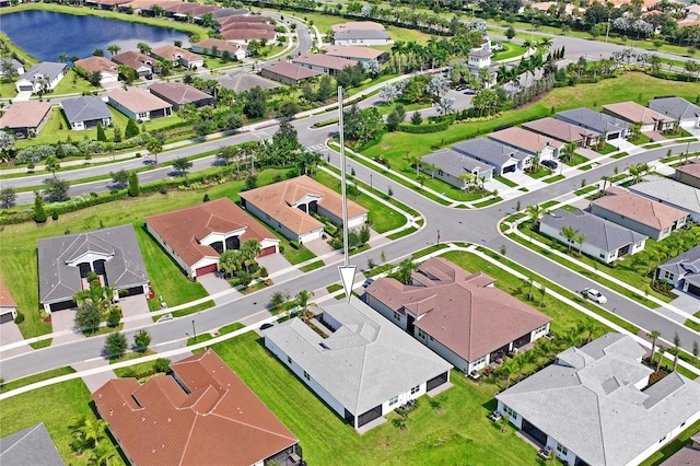 birds eye view of property with a residential view and a water view