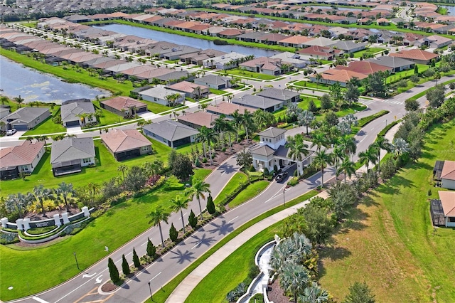 birds eye view of property with a water view and a residential view