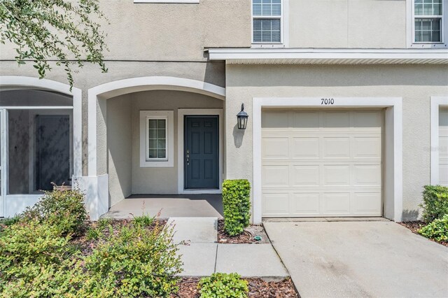 doorway to property with a garage