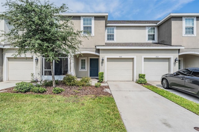 view of front of home with a front lawn and a garage