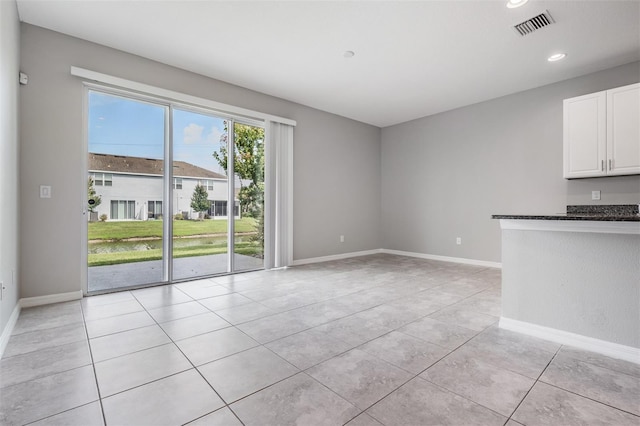 unfurnished living room featuring light tile patterned flooring