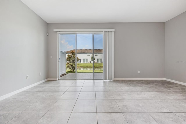 spare room featuring light tile patterned floors