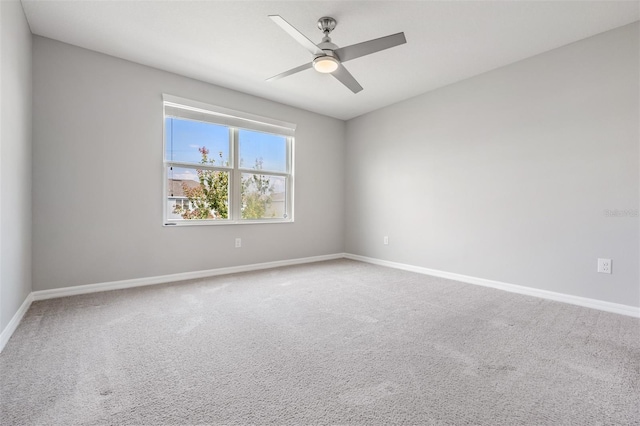 carpeted spare room featuring ceiling fan