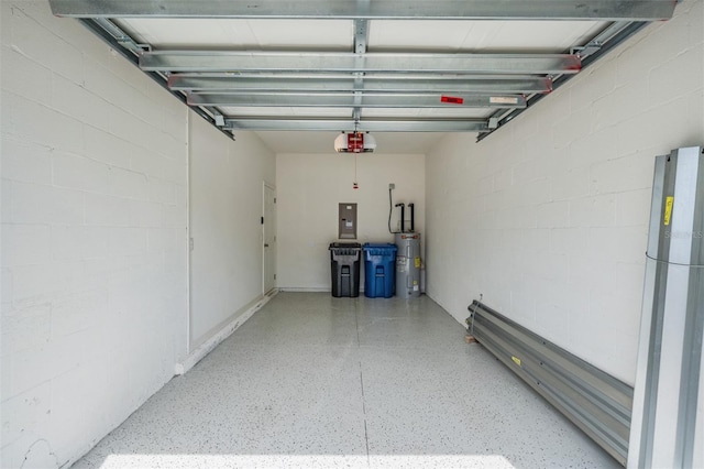 garage featuring a garage door opener, electric panel, and water heater