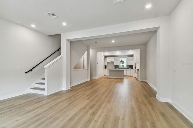 unfurnished living room with light hardwood / wood-style flooring