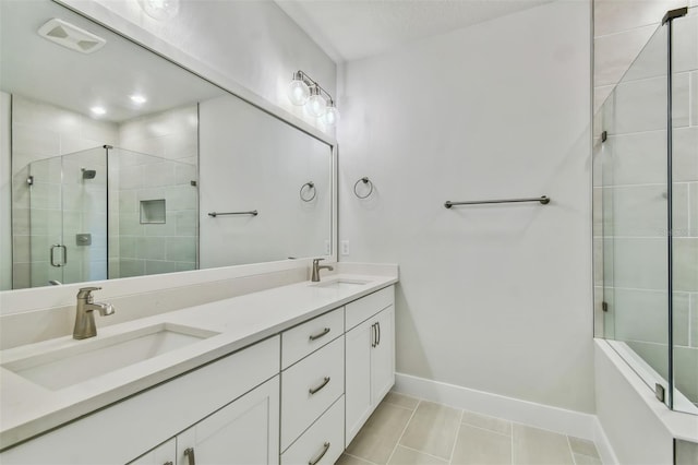 bathroom with vanity, tile patterned floors, and a shower with door