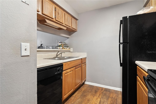 kitchen featuring sink, black appliances, and dark hardwood / wood-style floors