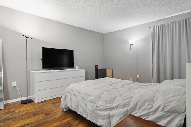 bedroom featuring wood-type flooring and a textured ceiling