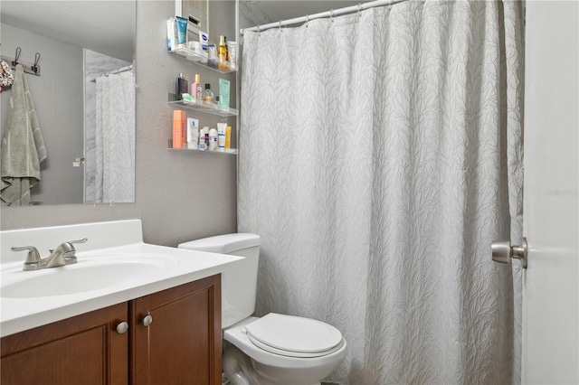 bathroom featuring toilet and vanity