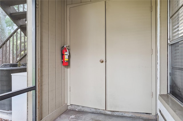 view of exterior entry featuring central AC unit