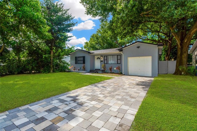 ranch-style house with a front yard and a garage