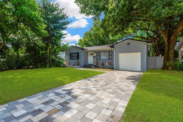 ranch-style home featuring a front lawn, decorative driveway, an attached garage, and stucco siding