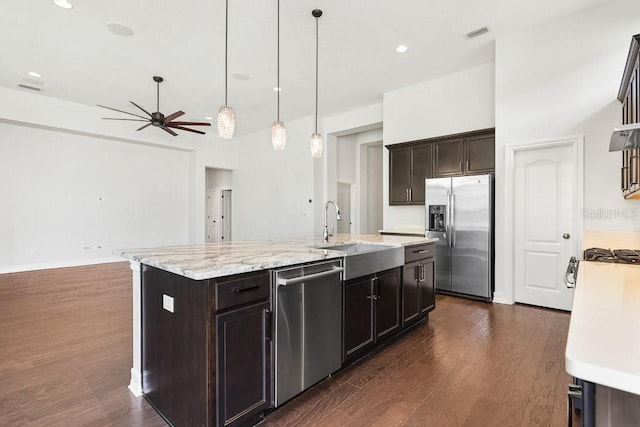 kitchen featuring sink, dark wood-type flooring, a kitchen island with sink, and stainless steel appliances