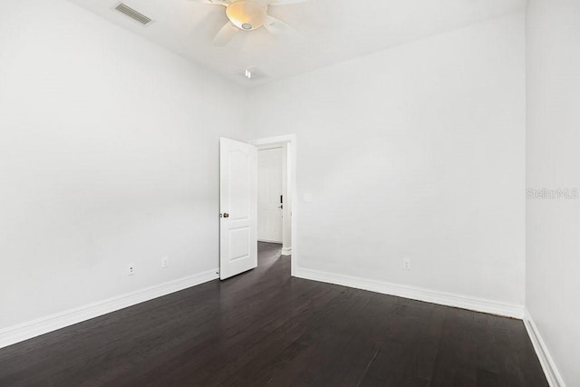 spare room with ceiling fan and dark hardwood / wood-style flooring