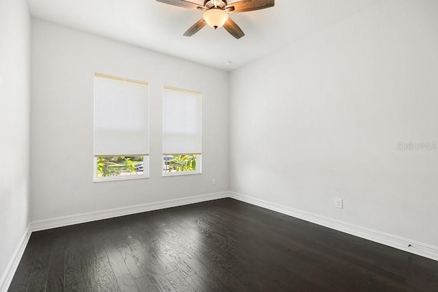 spare room with ceiling fan and dark hardwood / wood-style flooring