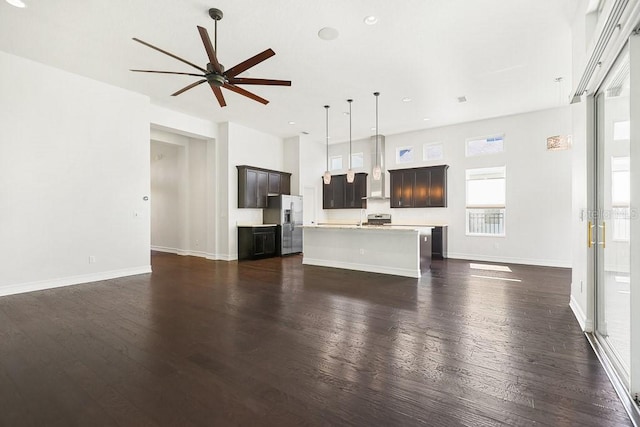 unfurnished living room featuring dark hardwood / wood-style floors and ceiling fan