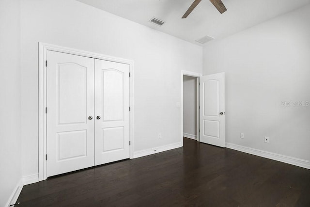 unfurnished bedroom with ceiling fan, a closet, and dark hardwood / wood-style flooring