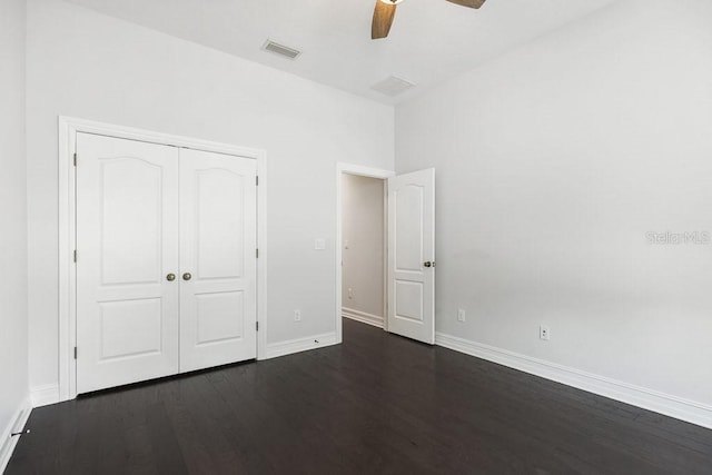 unfurnished bedroom featuring a closet, ceiling fan, and dark hardwood / wood-style floors