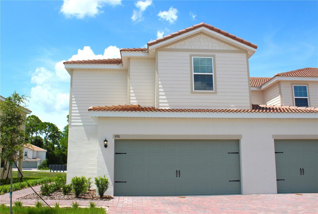 mediterranean / spanish house with a garage