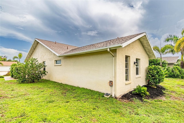 view of side of property with a lawn