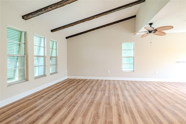 spare room with beam ceiling, light hardwood / wood-style floors, high vaulted ceiling, and ceiling fan