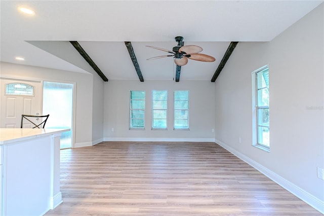 unfurnished living room with light wood-type flooring, vaulted ceiling with beams, and ceiling fan