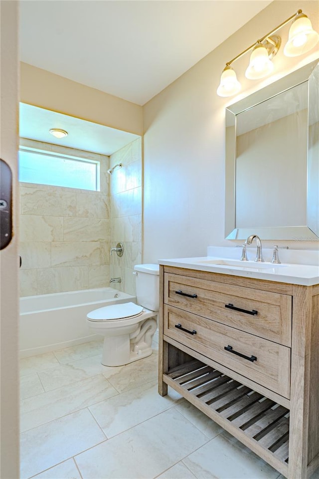 full bathroom with tiled shower / bath combo, vanity, and toilet