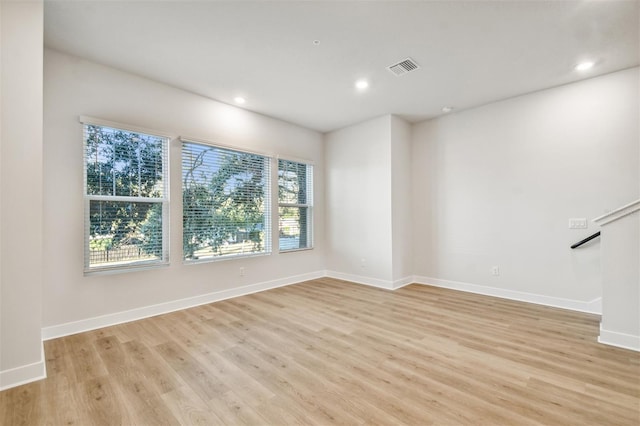 unfurnished room featuring light hardwood / wood-style floors and a wealth of natural light