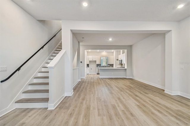 unfurnished living room featuring light wood-type flooring