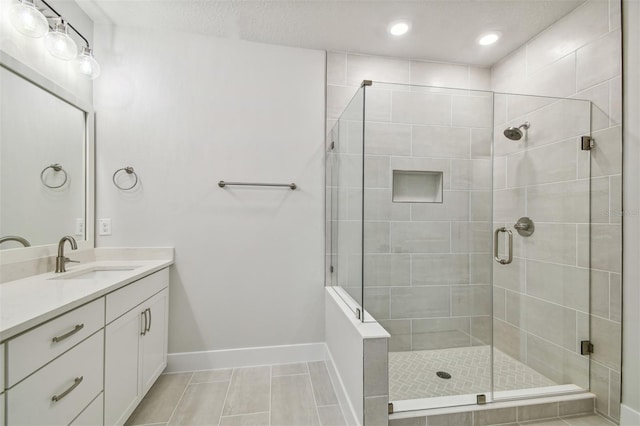 bathroom featuring vanity, tile patterned floors, and a shower with shower door