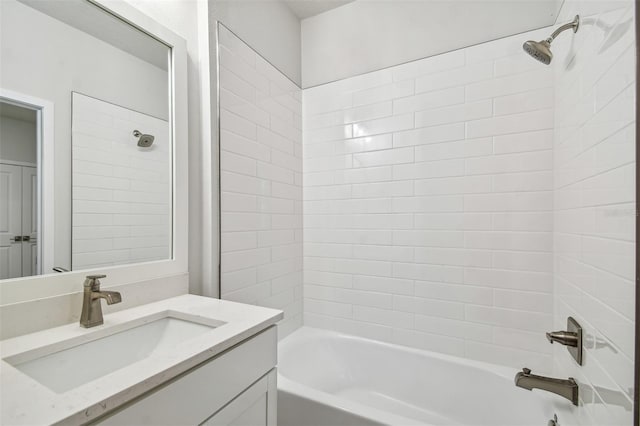 bathroom with vanity and tiled shower / bath