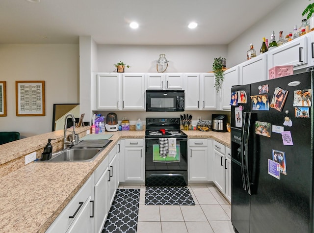 kitchen with white cabinetry, black appliances, sink, and light tile patterned floors