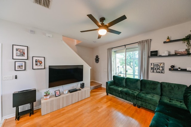 living room featuring hardwood / wood-style floors and ceiling fan