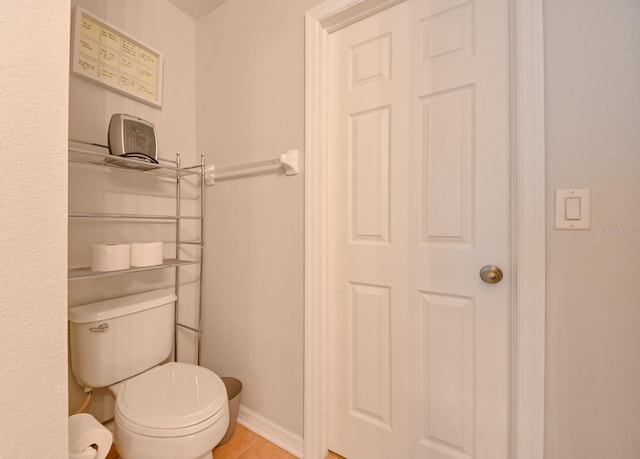 bathroom featuring tile patterned flooring and toilet