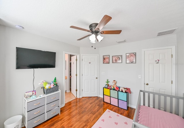 bedroom with light wood-type flooring and ceiling fan