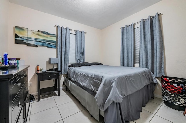 1611 Stevenson Dr, Clearwater, FL 33755 - bedroom with light tile patterned floors, baseboards, and a textured ceiling